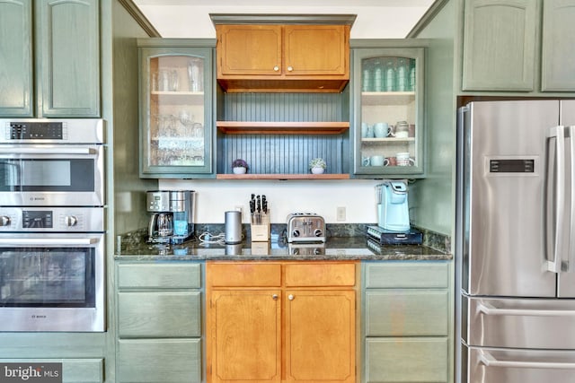 kitchen featuring dark stone counters and stainless steel appliances