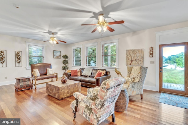 living room with ceiling fan, light hardwood / wood-style flooring, and plenty of natural light