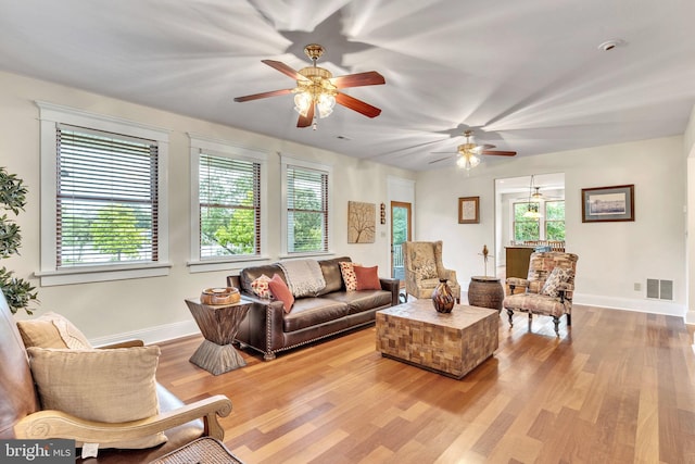 living room featuring ceiling fan and light hardwood / wood-style flooring