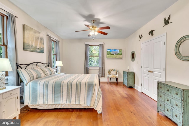 bedroom with ceiling fan and light hardwood / wood-style flooring