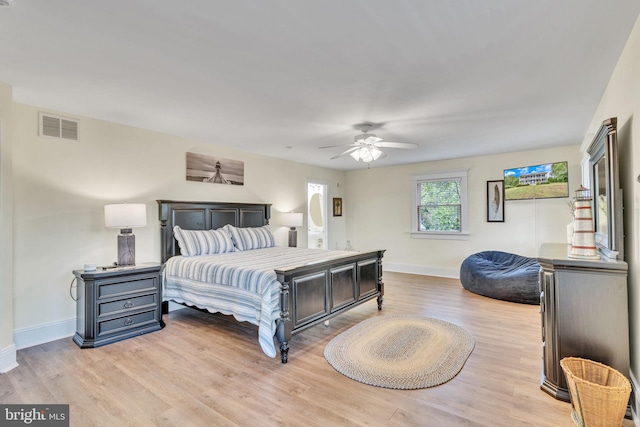 bedroom with ceiling fan and light hardwood / wood-style flooring