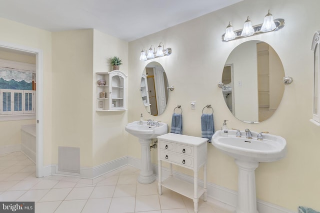 bathroom with double sink and tile patterned floors