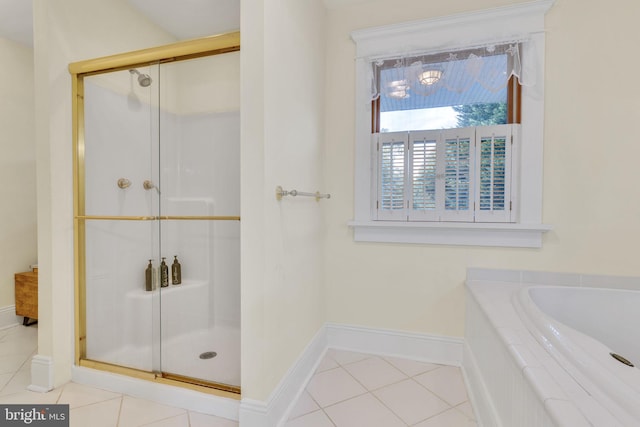 bathroom with independent shower and bath and tile patterned floors