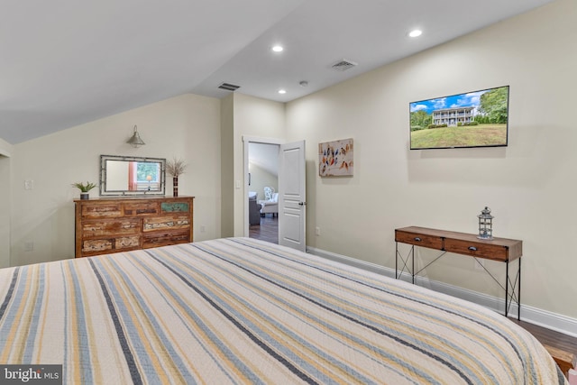 bedroom featuring lofted ceiling and hardwood / wood-style flooring