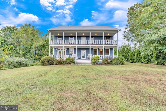 view of front facade with a balcony, a front lawn, and covered porch