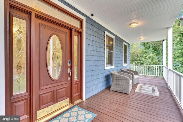 view of exterior entry featuring a porch