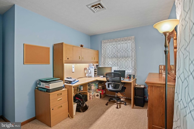 carpeted office with a textured ceiling