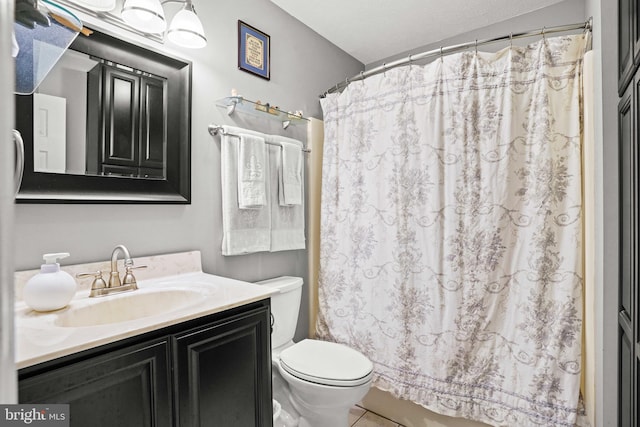 bathroom with vanity, toilet, and curtained shower