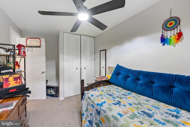 bedroom featuring ceiling fan, a closet, and light carpet