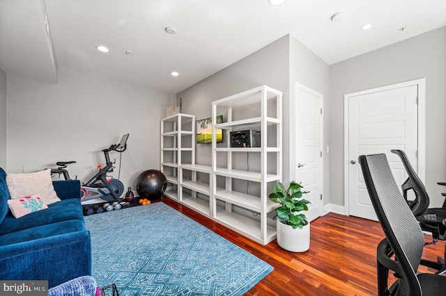 exercise area featuring hardwood / wood-style flooring