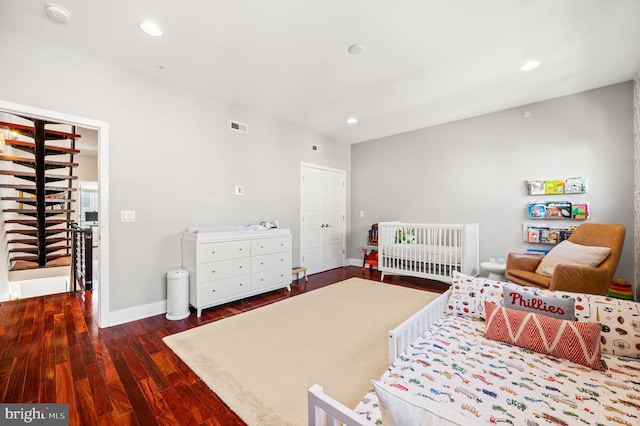 bedroom featuring dark hardwood / wood-style flooring