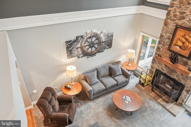 carpeted living room with a fireplace