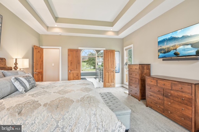 carpeted bedroom with a tray ceiling