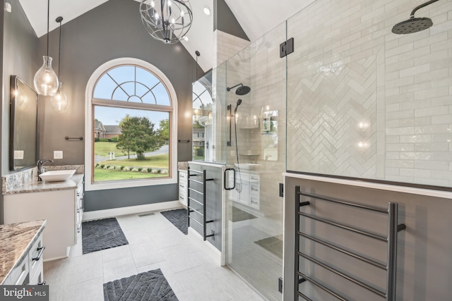 bathroom with vanity, tile patterned flooring, vaulted ceiling, and an enclosed shower