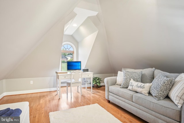 living room featuring vaulted ceiling and hardwood / wood-style flooring