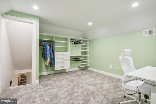 office with light carpet and vaulted ceiling