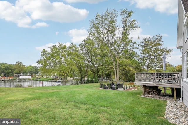 view of yard featuring a deck with water view