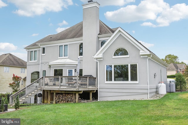 back of house with a yard and a wooden deck