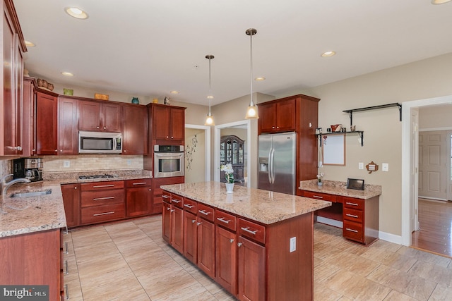 kitchen with sink, a center island, hanging light fixtures, stainless steel appliances, and light stone counters