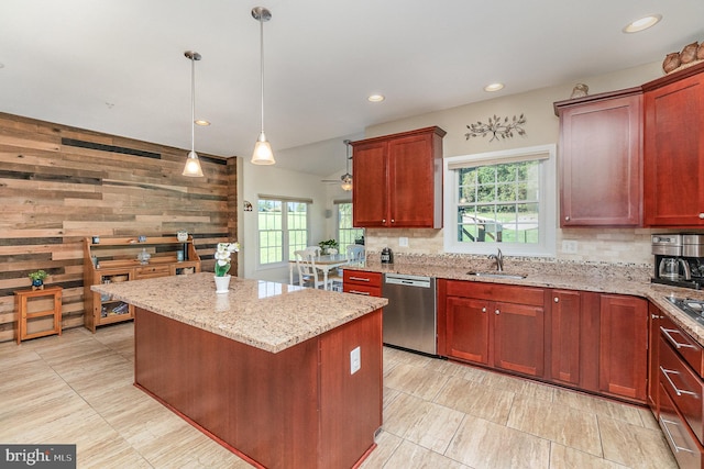 kitchen with wood walls, backsplash, a center island, pendant lighting, and stainless steel dishwasher