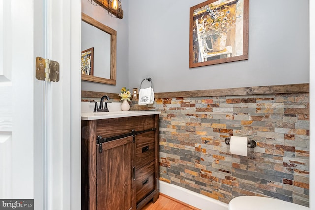 bathroom with vanity, hardwood / wood-style floors, and toilet