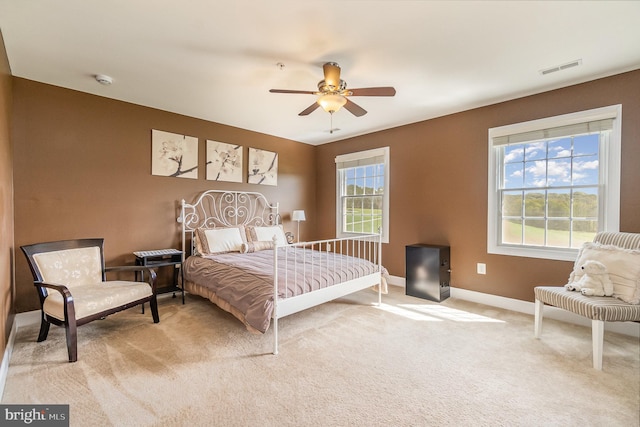 bedroom featuring light colored carpet and ceiling fan