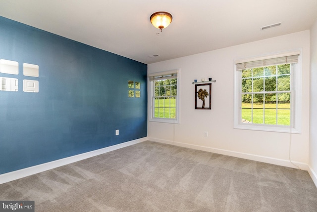 unfurnished room featuring light colored carpet