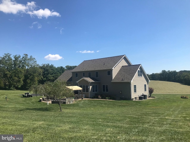 back of property featuring a yard and cooling unit