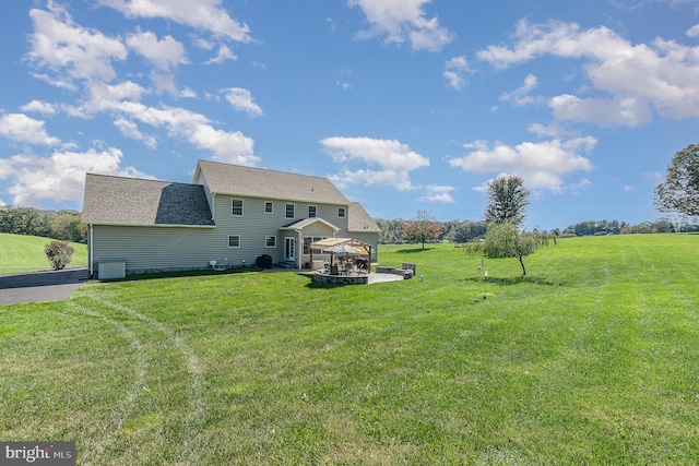 view of yard featuring a patio, a gazebo, a rural view, and a fire pit