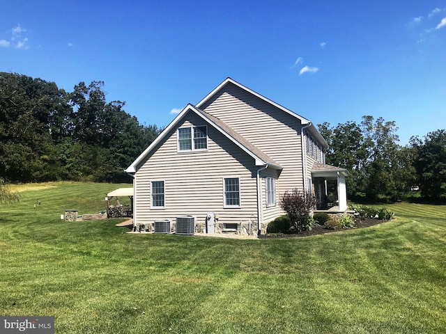 view of property exterior featuring a yard and central air condition unit