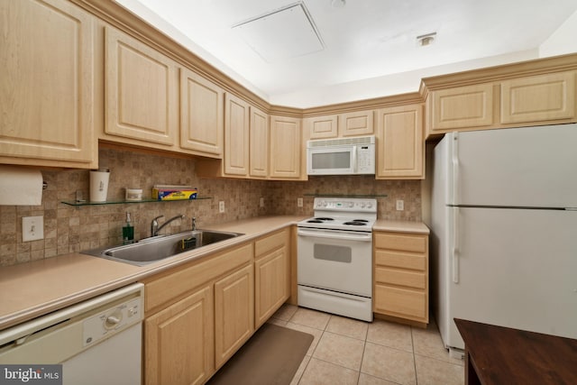 kitchen featuring sink, light brown cabinets, white appliances, and light tile patterned flooring