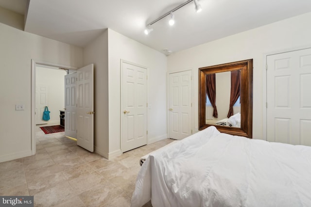 bedroom featuring track lighting