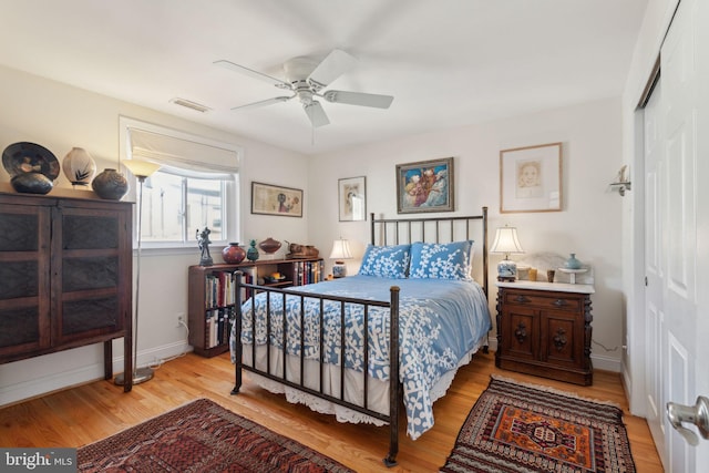 bedroom with a closet, ceiling fan, and light hardwood / wood-style floors