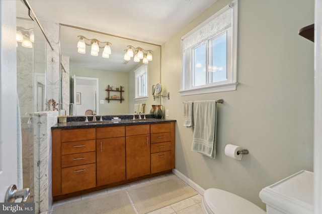 bathroom featuring tiled shower, vanity, toilet, and tile patterned floors