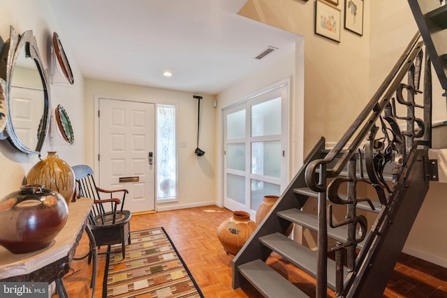 entryway featuring parquet floors