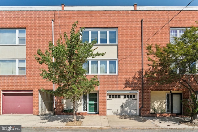 townhome / multi-family property featuring a garage