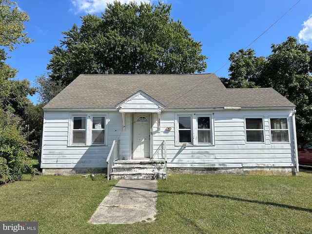 bungalow-style house featuring a front yard