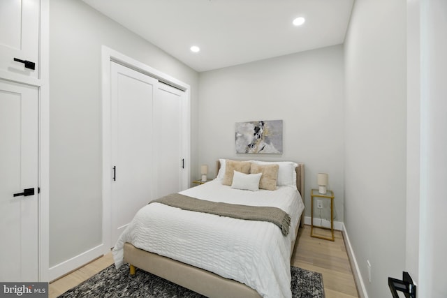 bedroom featuring a closet and light wood-type flooring