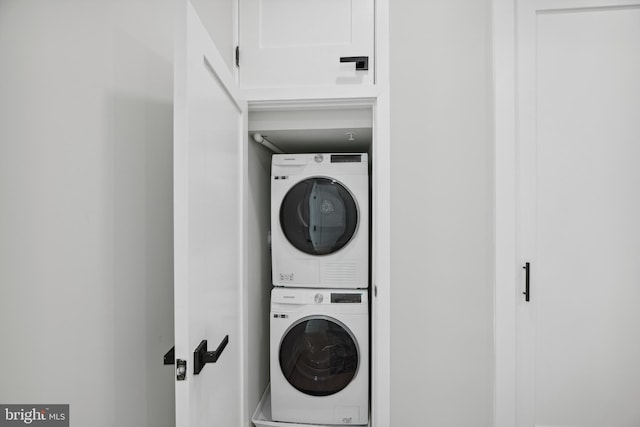 laundry room featuring stacked washing maching and dryer