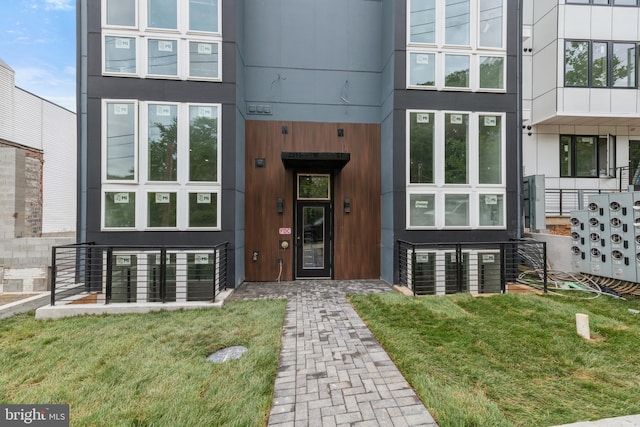 view of exterior entry featuring a yard and french doors