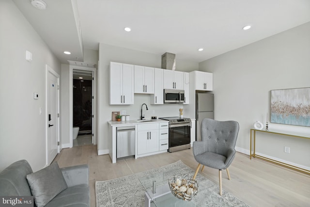 living room featuring light wood-type flooring and sink