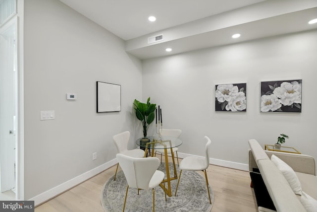 dining space with light hardwood / wood-style floors