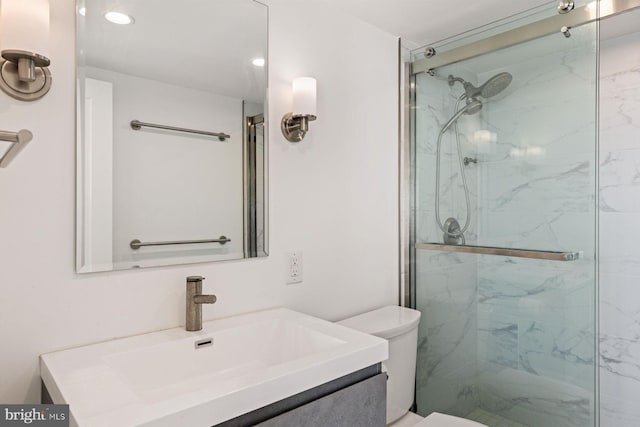 bathroom with vanity, toilet, and an enclosed shower