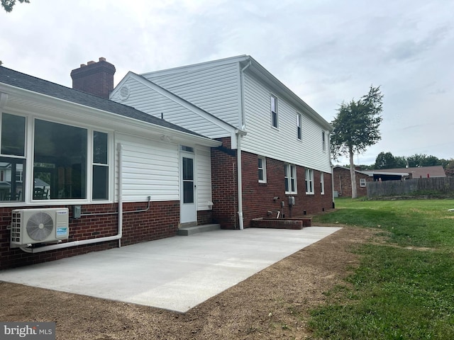 back of house with a patio, ac unit, and a yard