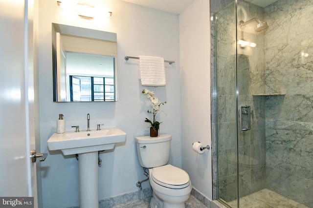 bathroom featuring toilet and a shower with door