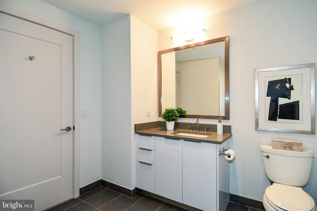 bathroom with tile patterned floors, vanity, and toilet