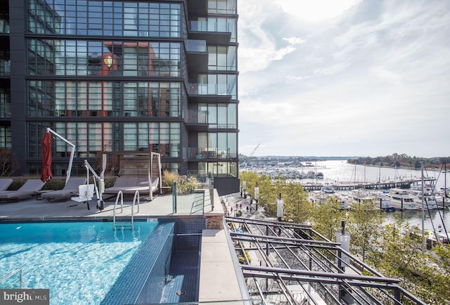 view of swimming pool with a water view