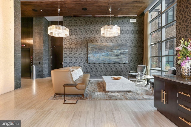 living area with a notable chandelier, wood ceiling, and light hardwood / wood-style floors