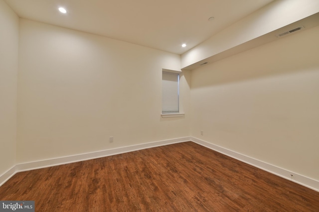 spare room featuring wood-type flooring