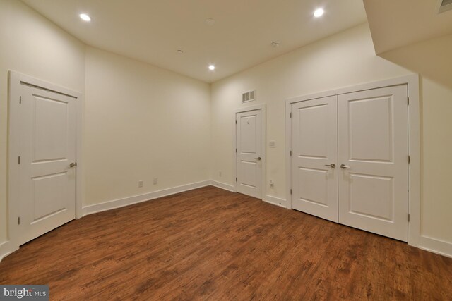 bonus room with dark wood-type flooring